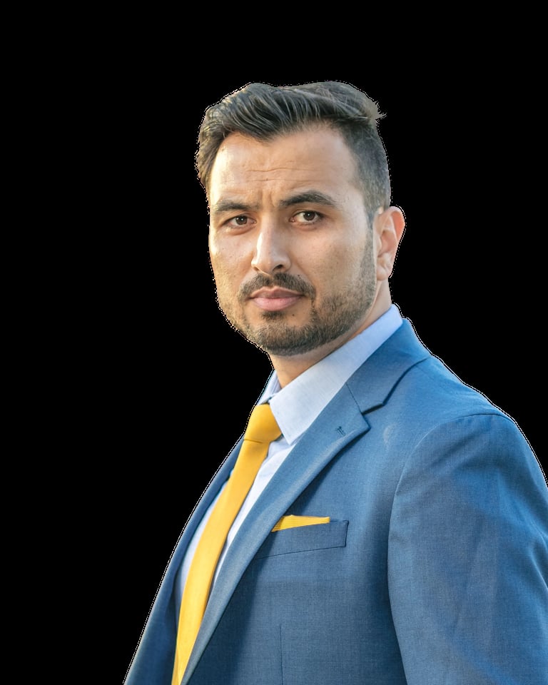 Professional headshot of a man in a blue blazer and yellow tie against a black background